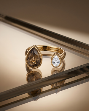 Gold open ring with brown teardrop center stone and clear round side stone