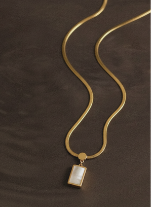 Gold-tone link chain with rectangular drop pendant, close view