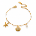 Gold seashell and starfish pearl bracelet with linked chain and lobster clasp
