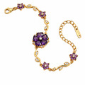 Gold bracelet with purple floral charm and crystal accents, adjustable clasp