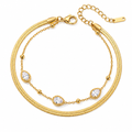 Gold layered chain bracelet with teardrop crystal charms and lobster clasp.