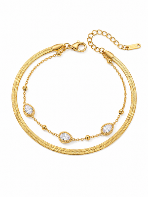 Gold layered chain bracelet with teardrop crystal charms and lobster clasp.