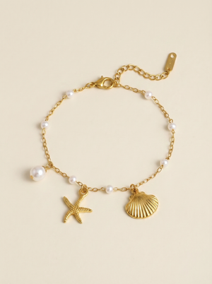 Gold pearl bracelet with starfish and seashell charms, small white pearl beads