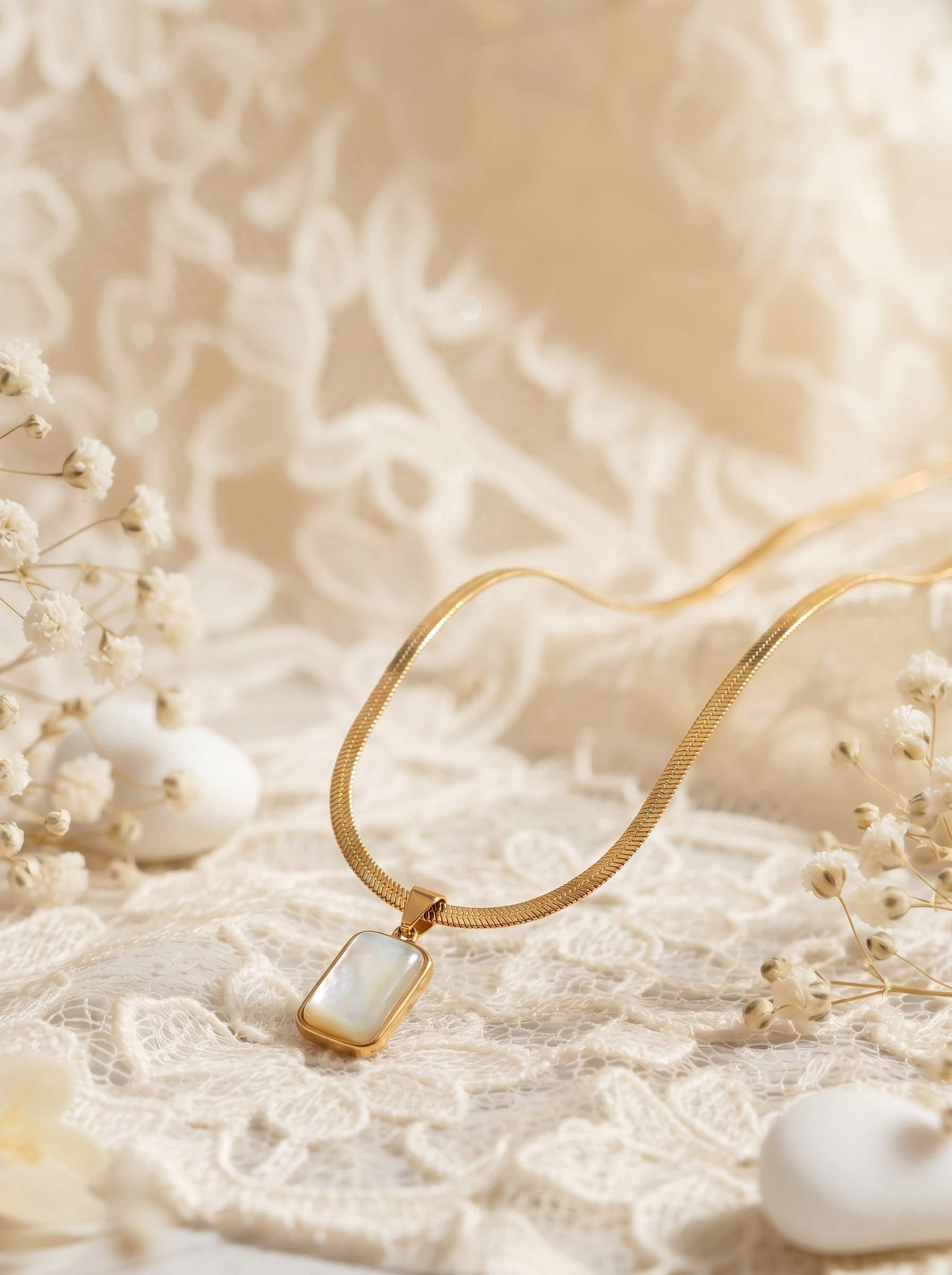Gold necklace with a white pendant on a soft beige background
