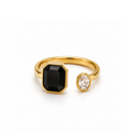 Gold ring with a black gemstone and a smaller clear gemstone on a white background
