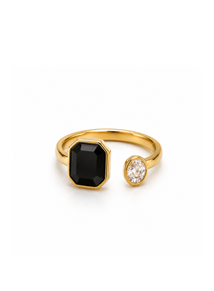 Gold ring with a black gemstone and a smaller clear gemstone on a white background